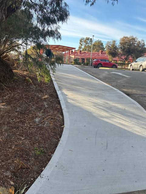 A curved shared path connecting to a car park