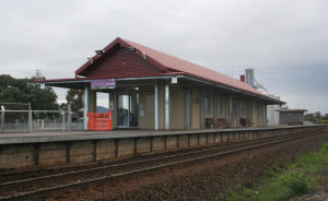 Lara Station building from the platform, with the silos behind