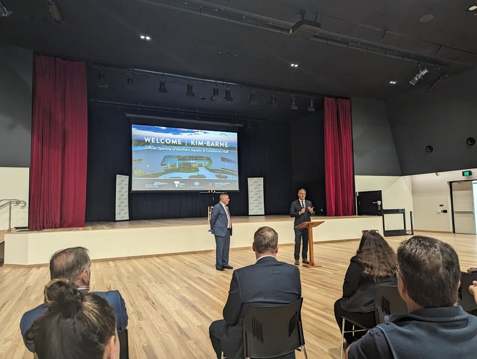 The official opening event in the hub's theatre space, with a welcome slide projected on stage
