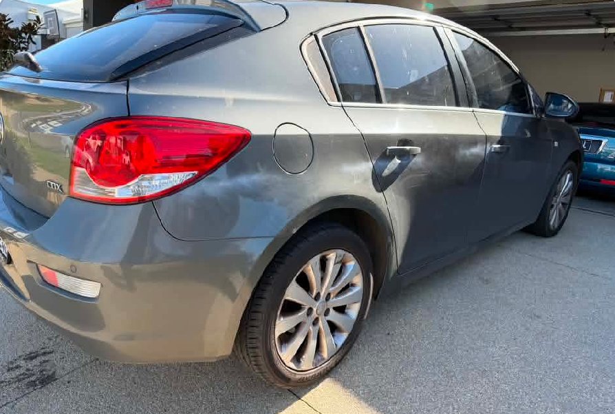 A grey hatchback in a workshop after professional paint correction