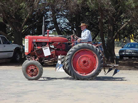 A restored red tractor at a Lara show day