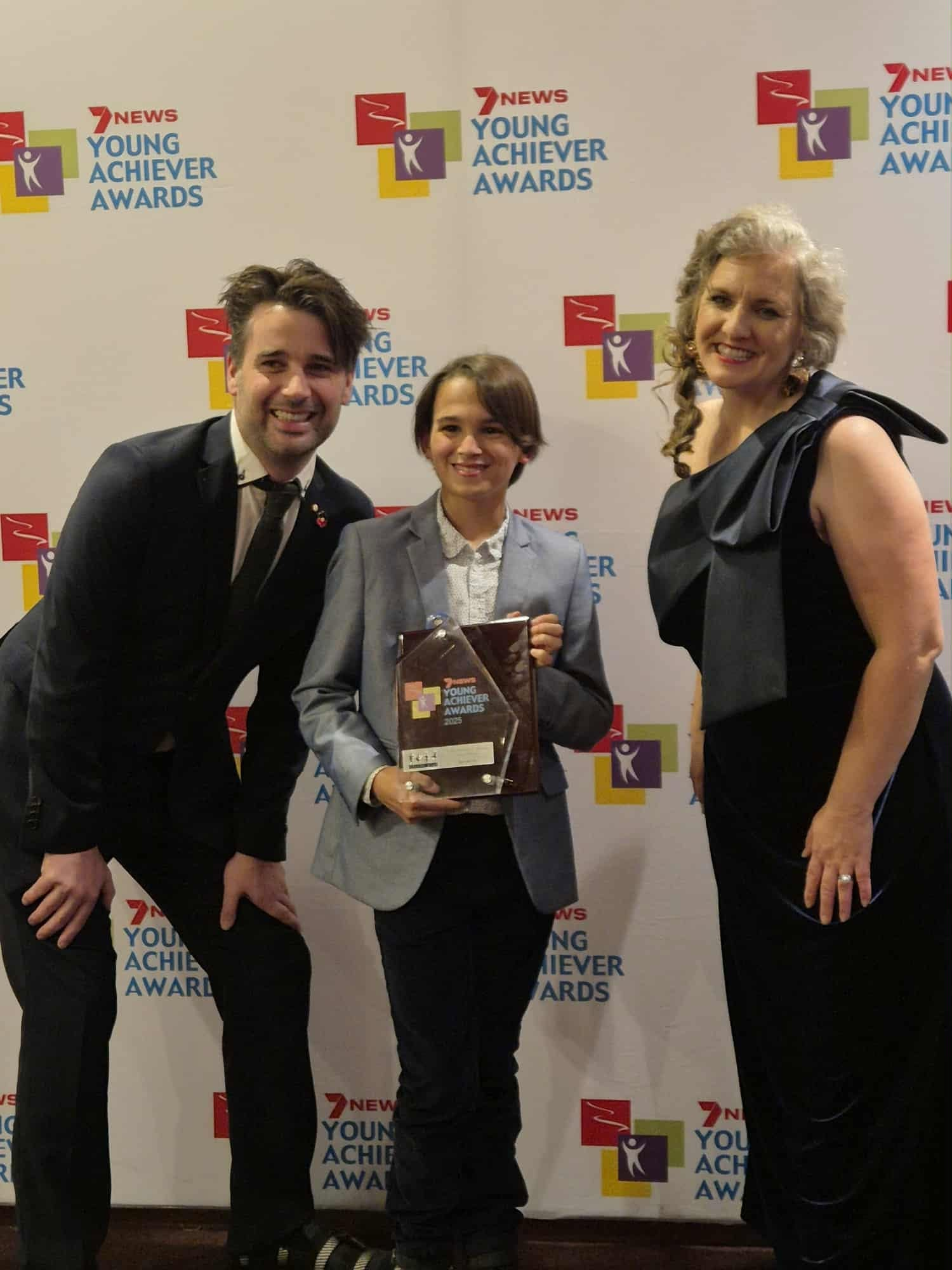 David Greenwood OAM and another guest with Daniel holding his award at the ceremony